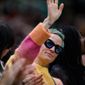 Soccer player Megan Rapinoe waves to the crowd during the second quarter of a WNBA basketball game between the Minnesota Lynx and the Seattle Storm on Friday, May 6, 2022, in Seattle. Rapinoe&#39;s fiancee, Sue Bird, plays for the Storm. (Jennifer Buchanan/The Seattle Times via AP)