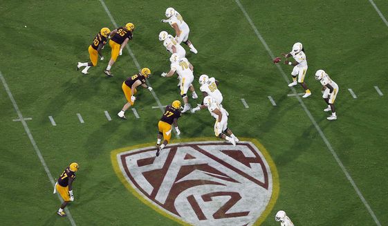 The Pac-12 logo is shown during the second half of an NCAA college football game between Arizona State and Kent State, in Tempe, Ariz. on Aug. 29, 2019. The Pac-12 announced, Wednesday, May 18, 2022, it was scrapping its divisional format for the coming season Wednesday, May 18, 2022. (AP Photo/Ralph Freso, File) **FILE**