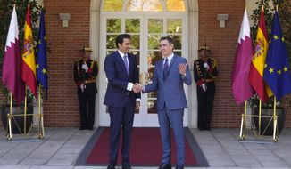 The Emir of Qatar Sheikh Tamim bin Hamad Al Thani, left, shakes hands with Spain&#39;s Prime Minister Pedro Sanchez at the Moncloa Palace in Madrid, Spain, Wednesday, May 18, 2022. The emir of Qatar said that his energy-rich gulf state is set to boost investments in Spain by 4.7 billion euros (4.9 billion) dollars in the coming years, Spanish media reported late on Tuesday. The details of the investments have not been made public but with Europe scrambling to find alternatives to Russian energy, Qatar is positioned to help fill the gap with exports of liquified natural gas. (AP Photo/Paul White)