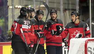 Canada&#39;s players celebrate after scoring during the group A Hockey World Championship match between Canada and Kazakhstan in Helsinki, Finland, Thursday May 19 2022. (AP Photo/Martin Meissner)