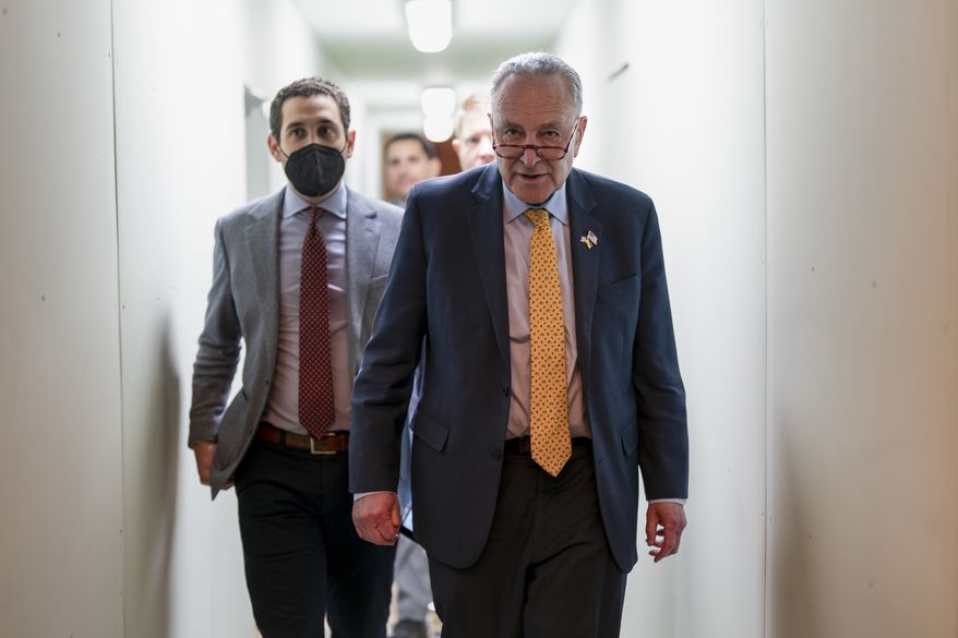 Senate Majority Leader Chuck Schumer, D-N.Y., walks through a construction tunnel at the Capitol on his way to welcome visiting Finnish President Sauli Niinisto and Swedish Prime Minister Magdalena Andersson, in Washington, Thursday, May 19, 2022. The two nations are moving quickly to try to join the North Atlantic Treaty Organization in response to Russia&#39;s invasion of Ukraine. (AP Photo/J. Scott Applewhite)