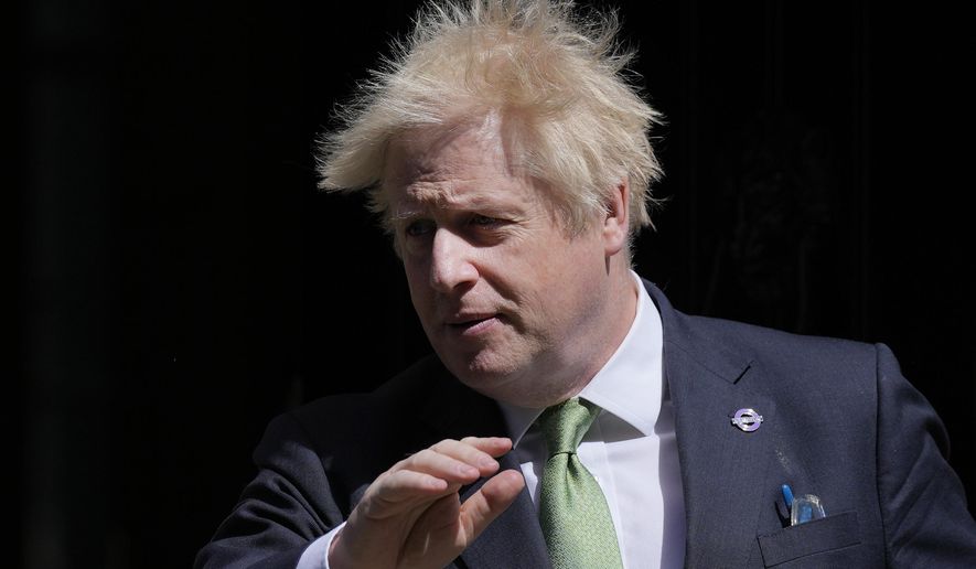 Britain's Prime Minister Boris Johnson leaves 10 Downing Street for the House of Commons for the weekly Prime Minister's Questions in London, Wednesday, May 18, 2022. (AP Photo/Alastair Grant)