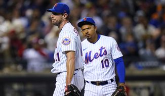 New York Mets third baseman Eduardo Escobar (10) checks on starting pitcher Max Scherzer during the sixth inning of the team&#39;s baseball game against the St. Louis Cardinals on Wednesday, May 18, 2022, in New York. (AP Photo/Frank Franklin II) ** FILE**