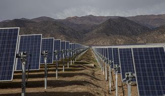 In this file photo, solar panels stand in the Quilapilún solar energy plant, a joint venture by Chile and China, in Colina, Chile, Aug. 20, 2019. (AP Photo/Esteban Felix, File)  **FILE**
