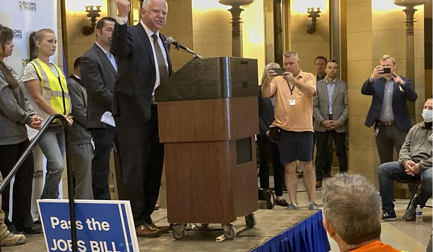 Democratic Minnesota Gov. Tim Walz addresses a labor rally on Thursday, May 19, 2022, at the State Capitol in St. Paul, Minnesota. He appeared one day before Minnesota Democrats open their state convention in Rochester. Walz and Lt. Gov. Peggy Flanagan will speak to delegates Friday, when they'll be endorsed for a second term. The governor said in an interview that he'll emphasize their successes in managing Minnesota through the coronavirus pandemic and the resulting challenges. (AP Photo/Steve Karnowski)
