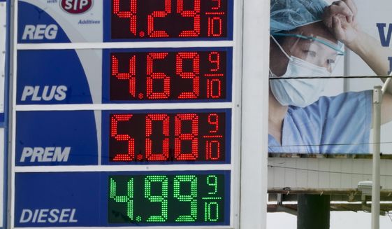 High gas prices are seen in front of a medical billboard Wednesday, May 11, 2022, in Milwaukee. (AP Photo/Morry Gash)