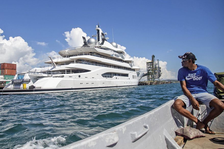 Boat captain Emosi Dawai looks at the superyacht Amadea where it is docked at the Queens Wharf in Lautoka, Fiji, on April 13, 2022. The superyacht that American authorities say is owned by a Russian oligarch previously sanctioned for alleged money laundering has been seized by law enforcement in Fiji, the U.S. Justice Department announced Thursday, May 5. (Leon Lord/Fiji Sun via AP, File)