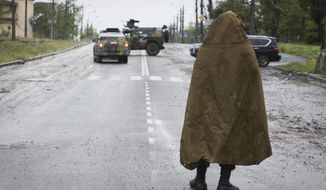 A serviceman of Donetsk People&#39;s Republic militia stands guard not far from the besieged Mariupol&#39;s Azovstal steel plant in Mariupol, in territory under the government of the Donetsk People&#39;s Republic, eastern Ukraine, Wednesday, May 18, 2022. (AP Photo)