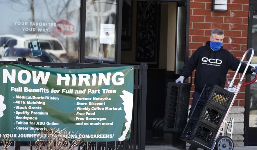 A hiring sign is displayed outside of a Starbucks in Schaumburg, Ill., Friday, April 1, 2022. The number of Americans applying for jobless aid ticked up slightly last week, but the total number of Americans collecting benefits remained at its lowest level in more than five decades. Applications for unemployment benefits rose by 1,000 to 203,000 for the week ending May 7, the Labor Department reported Thursday, May 12. (AP Photo/Nam Y. Huh)