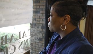 Alesia Horton, director of the West Alabama Women&#39;s Center in Tuscaloosa, Ala., looks out the window at protesters on Tuesday, March 15, 2022. A deeply religious woman, she says of those who picket the clinic: &amp;quot;God isn&#39;t theirs. God is all of ours.&amp;quot; (AP Photo/Allen G. Breed)