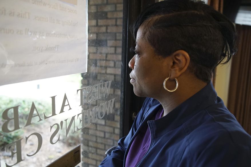 Alesia Horton, director of the West Alabama Women&#39;s Center in Tuscaloosa, Ala., looks out the window at protesters on Tuesday, March 15, 2022. A deeply religious woman, she says of those who picket the clinic: &amp;quot;God isn&#39;t theirs. God is all of ours.&amp;quot; (AP Photo/Allen G. Breed)