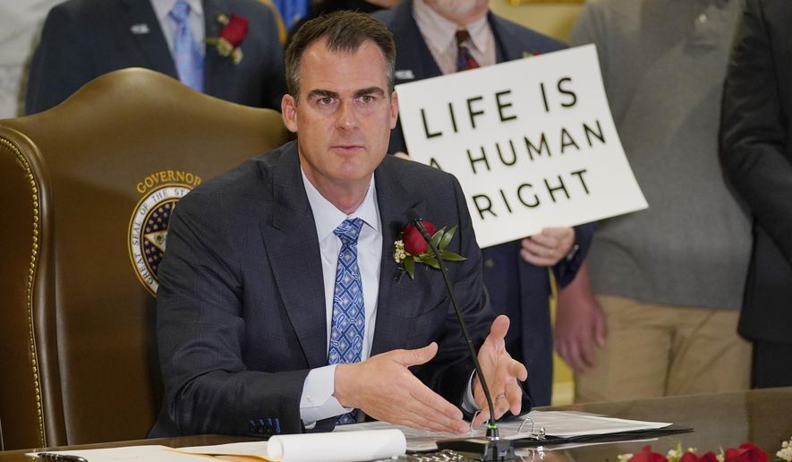In this April 12, 2022, file photo, Oklahoma Gov. Kevin Stitt speaks after signing into law a bill making it a felony to perform an abortion, punishable by up to 10 years in prison in Oklahoma City. Oklahoma&#39;s Legislature has given final legislative approval to another Texas-style anti-abortion bill. Abortion providers say once the bill is signed, it would be the most restrictive abortion ban in effect in the country. (AP Photo/Sue Ogrocki, file)