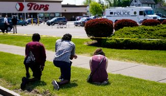 FILE - People pray outside the scene of a shooting where police are responding at a supermarket, in Buffalo, N.Y., May 15, 2022. When police confronted Payton Gendron, the white man suspected of killing 10 Black people at the supermarket, he had an AR-15-style rifle and was cloaked in body armor. Yet officers talked to Gendron, convinced him to put down his weapon and arrested him without firing a single shot. Some people are asking why that type of treatment hasn&#39;t been afforded to Black people in encounters where they were killed over minor traffic infractions, or no infractions at all. (AP Photo/Matt Rourke, File)