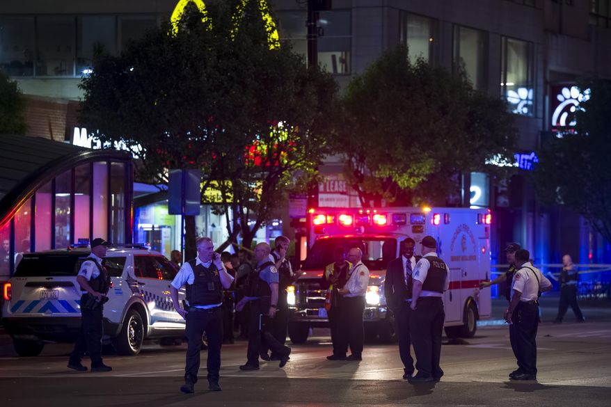 Chicago police work at the scene of a shooting near East Chicago Avenue and North State Street in the Near North Side neighborhood, Thursday, May 19, 2022 in Chicago. (Tyler Pasciak LaRiviere/Chicago Sun-Times via AP)