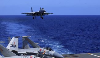 In this photo released Dec. 31, 2021, by Xinhua News Agency, an undated photo shows a carrier-based J-15 fighter jet preparing to land on the Chinese navy&#39;s Liaoning aircraft carrier during open-sea combat training. China is holding military exercises in the disputed South China Sea coinciding with U.S. President Joe Biden&#39;s visits to South Korea and Japan that are largely focused on countering the perceived threat from China. (Hu Shanmin/Xinhua via AP) ** FILE **
