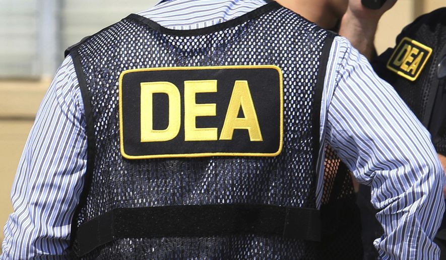 FILE - This June 13, 2016, file photo shows Drug Enforcement Administration agents in Florida.  A current U.S. Drug Enforcement Administration agent and a former supervisor in the agency were indicted Friday, May 20, 2022 on federal charges accusing them of leaking confidential law enforcement information to defense lawyers in Florida in exchange for cash and gifts. (Joe Burbank/Orlando Sentinel via AP)
