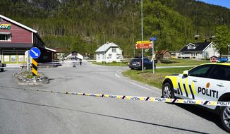 A police car on the scene of a multiple stabbing in Nore, Norway, Friday, May 20, 2022. Norwegian police say a person with a knife has wounded at least three people — one of them critically — in an attack in a town near Oslo. They say the perpetrator has been arrested.(Lise Åserud/NTB Scanpix via AP)