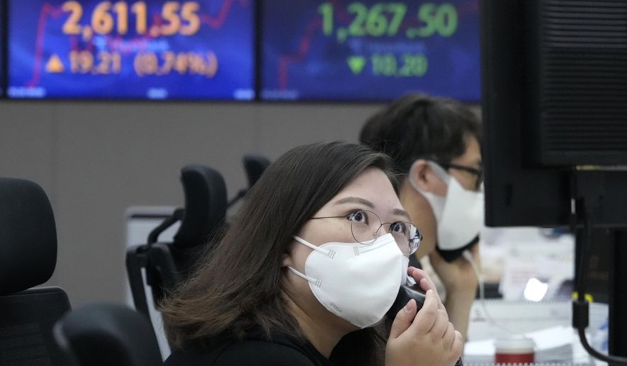 A currency trader watches monitors at the foreign exchange dealing room of the KEB Hana Bank headquarters in Seoul, South Korea, Friday, May 20, 2022. Asian stock markets rose Friday after Wall Street fell closer to bear territory, China cut a key interest rate and Japanese inflation edged higher. (AP Photo/Ahn Young-joon)