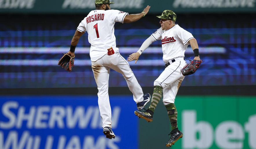 Cleveland Guardians&#39; Amed Rosario (1) and Myles Straw celebrate a win over the Detroit Tigers in a baseball game, Friday, May 20, 2022, in Cleveland. (AP Photo/Ron Schwane)