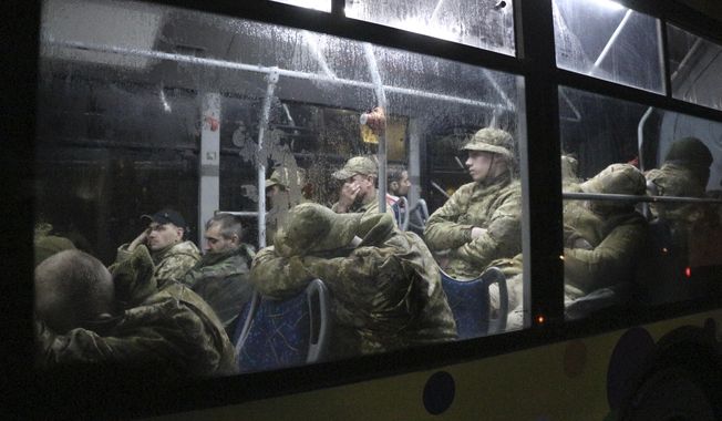 Ukrainian servicemen sit in a bus after leaving Mariupol&#x27;s besieged Azovstal steel plant, near a penal colony, in Olyonivka, in territory under the government of the Donetsk People&#x27;s Republic, eastern Ukraine, Friday, May 20, 2022. (AP Photo)