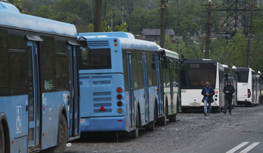 Buses wait for Ukrainian servicemen to transport them from Mariupol to a penal colony in Olyonivka after leaving Mariupol&#39;s besieged Azovstal steel plant, in Mariupol, in territory under the government of the Donetsk People&#39;s Republic, eastern Ukraine, Thursday, May 19, 2022. (AP Photo)