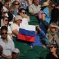 FILE - A spectator holding a Russian flag watches during the men&#39;s singles third round match between Russia&#39;s Daniil Medvedev and Croatia&#39;s Marin Cilic on day six of the Wimbledon Tennis Championships in London, Saturday July 3, 2021. The ATP men’s professional tennis tour will not award ranking points for Wimbledon this year because of the All England Club’s ban on players from Russia and Belarus over the invasion of Ukraine. The ATP announced its decision Friday night, May 20, 2022, two days before the start of the French Open — and a little more than a month before play begins at Wimbledon on June 27. It is a highly unusual and significant rebuke of the oldest Grand Slam tournament. (AP Photo/Alberto Pezzali, File)