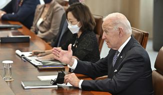 U.S. President Joe Biden, right, talks with South Korean President Yoon Suk Yeol, not in photo, during their meeting at the People&#39;s House in Seoul Saturday, May 21, 2022. (Jung Yeon-je /Pool Photo via AP)