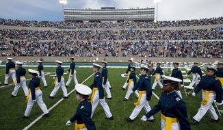Air Force Academy cadets make their way to their seats as family and friends cheer from the stands during the United States Air Force Academy&#39;s Class of 2021 graduation ceremony at the USAFA in Colorado Springs, Colo., May 26, 2021. (Chancey Bush/The Gazette via AP, File)