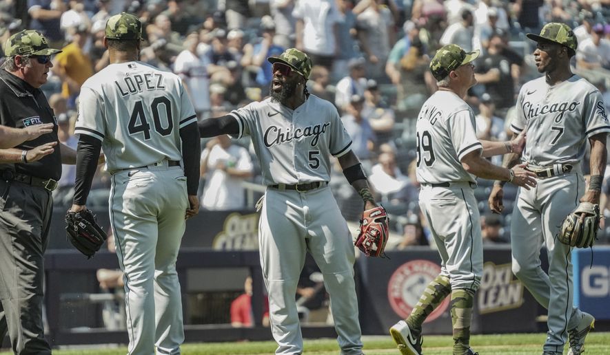 Umpires, left, call for calm while Chicago White Sox third base coach Joe McEwing (99), second from right, holds back White Sox shortstop Tim Anderson (7) during a baseball game against the New York Yankees, Saturday May 21, 2022, in New York. (AP Photo/Bebeto Matthews)
