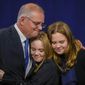 Australian Prime Minister Scott Morrison hugs his daughters Lily and Abbey at a Liberal Party function in Sydney, Australia, Saturday, May 21, 2022. Morrison has conceded defeat and has confirmed that he would hand over the leadership of the Liberal Party following his party&#39;s loss to Labor in today&#39;s federal election. (AP Photo/Mark Baker)