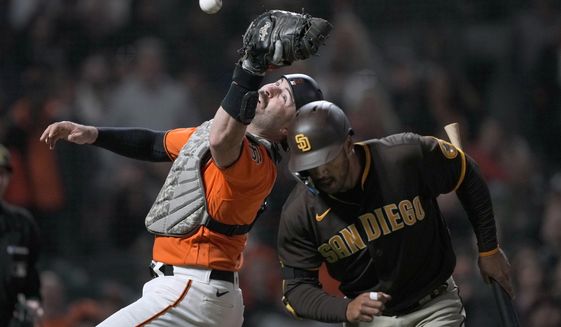San Francisco Giants catcher Curt Casali drops a foul ball next to San Diego Padres&#39; Trent Grisham during the seventh inning of a baseball game in San Francisco, Friday, May 20, 2022. (AP Photo/Tony Avelar)