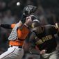 San Francisco Giants catcher Curt Casali drops a foul ball next to San Diego Padres&#39; Trent Grisham during the seventh inning of a baseball game in San Francisco, Friday, May 20, 2022. (AP Photo/Tony Avelar)