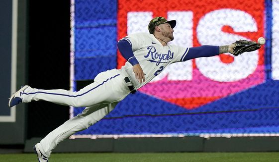 Kansas City Royals center fielder Kyle Isbel can&#39;t catch a two-run double hit by Minnesota Twins&#39; Jose Miranda during the eighth inning of a baseball game Friday, May 20, 2022, in Kansas City, Mo. (AP Photo/Charlie Riedel)