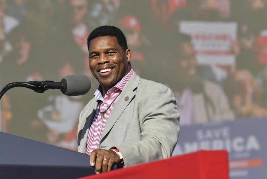 Republican U.S. Senate candidate Herschel Walker speaks during a Donald Trump rally for Georgia GOP candidates in Commerce, Ga., March 26, 2022. Walker boasts of his charity work helping members of the military who struggle with mental health. The football legend and leading Republican Senate candidate in Georgia says the outreach is done through a program he created, called Patriot Support. But court filings and company documents offer a more complicated picture.(Hyosub Shin/Atlanta Journal-Constitution via AP, File)