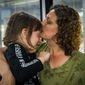 Kristie Graves gives her 6-year-old adopted daughter, Bridget, a kiss while on a bus at Dulles International Airport on Thursday, May 12, 2022, near Dulles, Va. The family arrived at the airport after going to war-torn Ukraine to finalize the adoption of Bridget and bring her home. (Katina Zentz/The Frederick News-Post via AP)