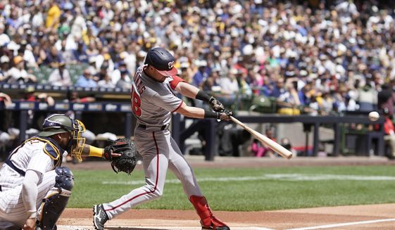 Washington Nationals&#39; Lane Thomas hits an RBI double during the second inning of a baseball game against the Milwaukee Brewers Sunday, May 22, 2022, in Milwaukee. (AP Photo/Morry Gash)