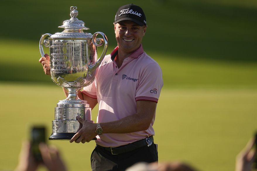 Justin Thomas holds the Wanamaker Trophy after winning the PGA Championship golf tournament in a playoff against Will Zalatoris at Southern Hills Country Club, Sunday, May 22, 2022, in Tulsa, Okla. (AP Photo/Sue Ogrocki)