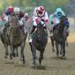 Jose Ortiz, second from right, atop Early Voting, heads to the finish line while winning the 147th running of the Preakness Stakes horse race at Pimlico Race Course, Saturday, May 21, 2022, in Baltimore. (AP Photo/Nick Wass) **FILE**