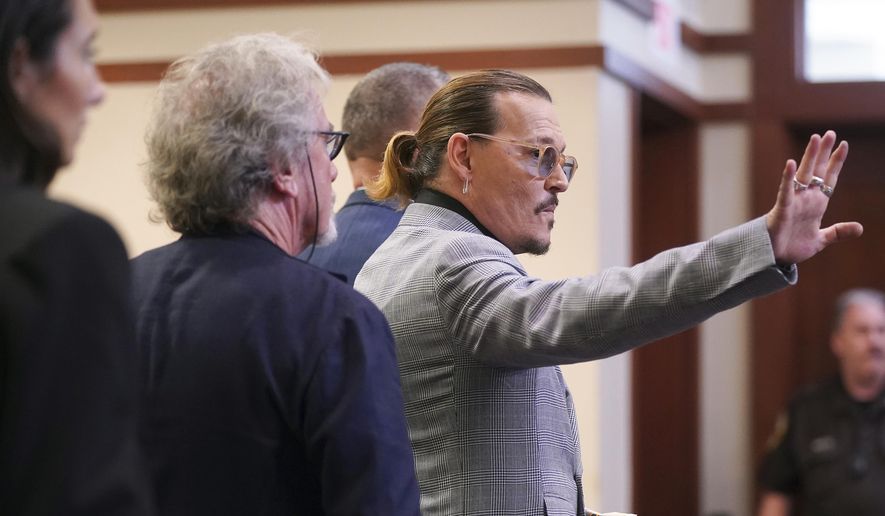 Actor Johnny Depp waves as he leaves the courtroom at the Fairfax County Circuit Courthouse in Fairfax, Va., Thursday, May 19, 2022. Actor Johnny Depp sued his ex-wife Amber Heard for libel in Fairfax County Circuit Court after she wrote an op-ed piece in The Washington Post in 2018 referring to herself as a &amp;quot;public figure representing domestic abuse.&amp;quot; (Shawn Thew/Pool Photo via AP)