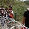 Migrants walk past razor wire fencing to be taken by the Border Patrol after crossing the Rio Grande river towards the U.S. in Eagle Pass, Texas, Sunday, May 22, 2022. The U.S. government has expelled migrants more than 1.9 million times under Title 42, named for a 1944 public health law, denying them a chance to seek asylum as permitted under U.S. law and international treaty for purposes of preventing the spread of COVID-19. President Joe Biden wanted to end Title 42, but a federal judge in Louisiana issued a nationwide injunction that keeps it intact. (AP Photo/Dario Lopez-Mills)