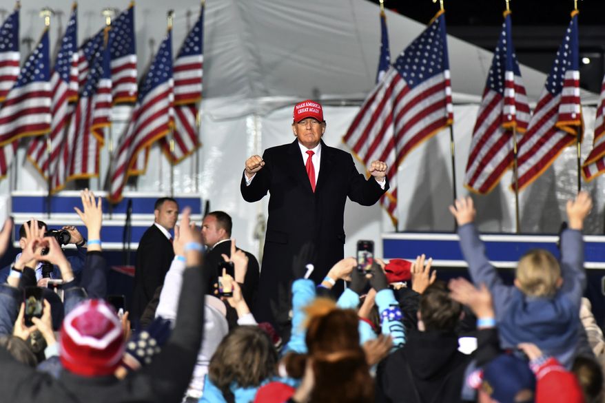 In this file photo, Former President Donald Trump dances as he leaves the stage during a rally for Georgia GOP candidates at Banks County Dragway in Commerce, Ga., March 26, 2022. (Hyosub Shin/Atlanta Journal-Constitution via AP)