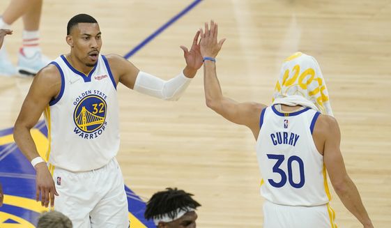 Golden State Warriors forward Otto Porter Jr. (32) and guard Stephen Curry during Game 2 of the NBA basketball playoffs Western Conference finals against the Dallas Mavericks in San Francisco, Friday, May 20, 2022. (AP Photo/Jeff Chiu) **FILE**