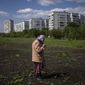 Lyudmila, 85, tends to the garden in Kharkiv, eastern Ukraine, Monday, May 23, 2022. (AP Photo/Bernat Armangue)