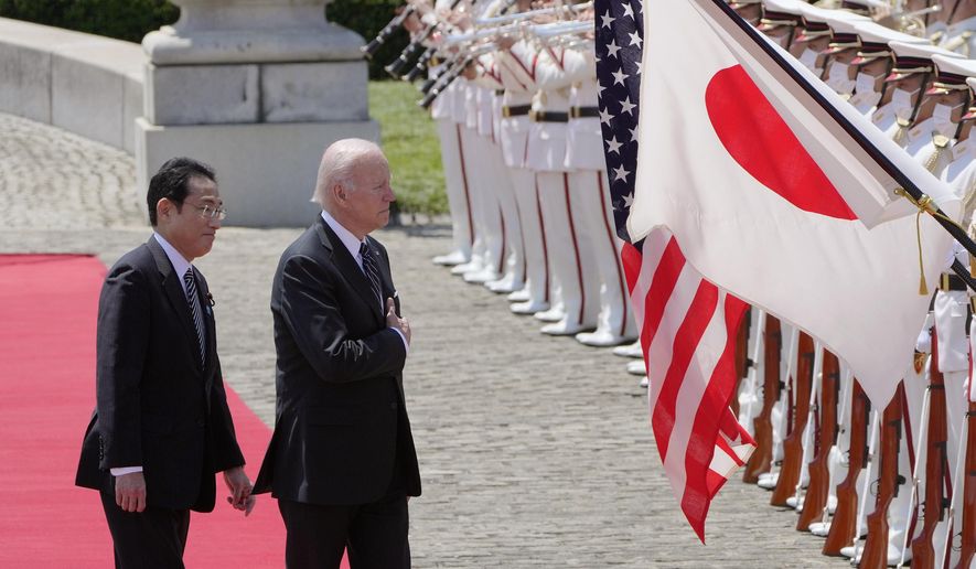U.S. President Joe Biden, right, and Japan&#x27;s Prime Minister Fumio Kishida review an honor guard during a welcome ceremony for President Biden, at the Akasaka Palace state guest house in Tokyo, Japan, Monday, May 23, 2022. (AP Photo/Eugene Hoshiko, Pool) **FILE**