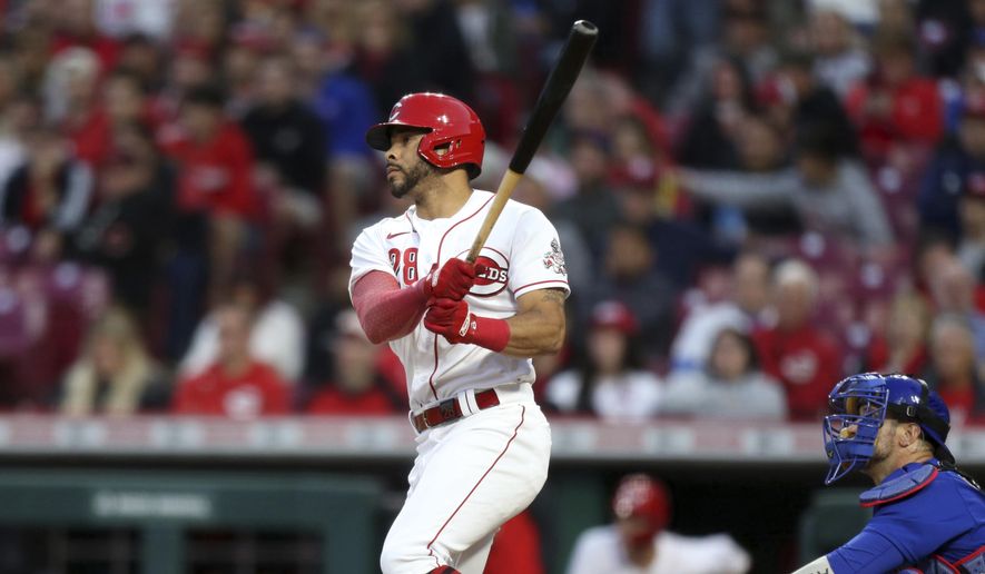 Cincinnati Reds&#39; Tommy Pham, left, watches his home run in front of Chicago Cubs catcher Yan Gomes during the sixth inning of a baseball game in Cincinnati, Monday, May 23, 2022. (AP Photo/Paul Vernon) **FILE**