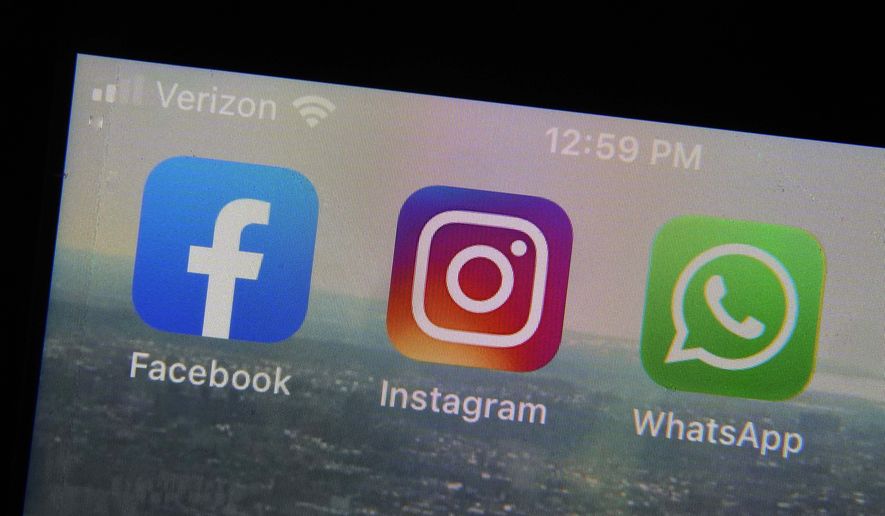 The mobile phone apps for, from left, Facebook, Instagram and WhatsApp are shown on a device in New York. (AP Photo/Richard Drew, File)