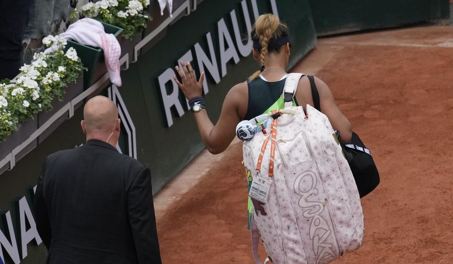 Japan&#39;s Naomi Osaka leaves after losing against Amanda Anisimova of the U.S. during their first round match at the French Open tennis tournament in Roland Garros stadium in Paris, France, Monday, May 23, 2022. (AP Photo/Christophe Ena)