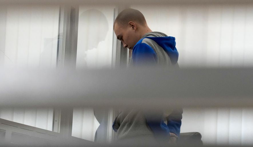 Russian Sgt. Vadim Shishimarin attends a court hearing in Kyiv, Ukraine, Monday, May 23, 2022. The 21-year-old soldier facing the first war crimes trial since the start of the war in Ukraine plead guilty on May 18 to killing an unarmed civilian. (AP Photo/Natacha Pisarenko)