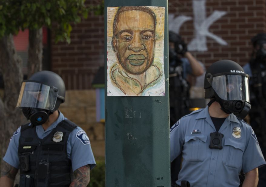Minneapolis police stand outside the department&#39;s 3rd Precinct on May 27, 2020, in Minneapolis. (Carlos Gonzalez/Star Tribune via AP, File)