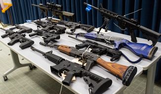 Weapons are displayed during a news conference in Los Angeles on Feb. 22, 2022, after state and regional law enforcement seized 114 guns from people legally prohibited from owning firearms during a five-day sweep across 51 cities in the Los Angeles area. Spurred by the Tuesday, May 24, 2022, deadly elementary school shooting in Texas, California senators approved giving citizens the power to sue those who traffic in illegal firearms, mimicking a Texas law that is intended to deter abortions. (Eric Licas/The Orange County Register via AP, File)